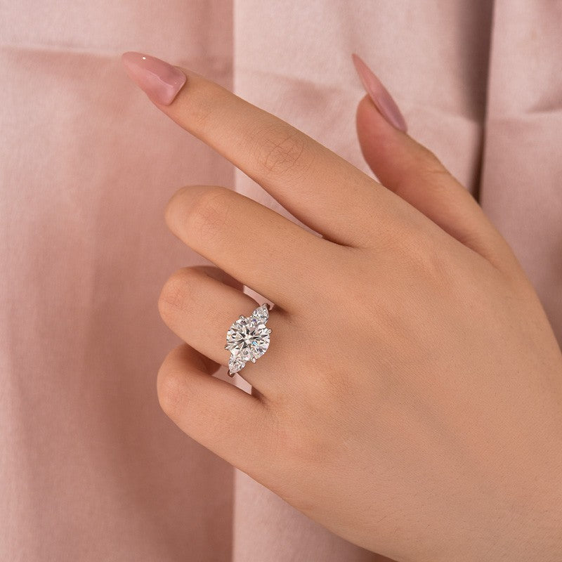 Aurevyn Moissanite 4.0 Ct Round Cut White Gold Engagement Ring with Pear Cut Side Stone