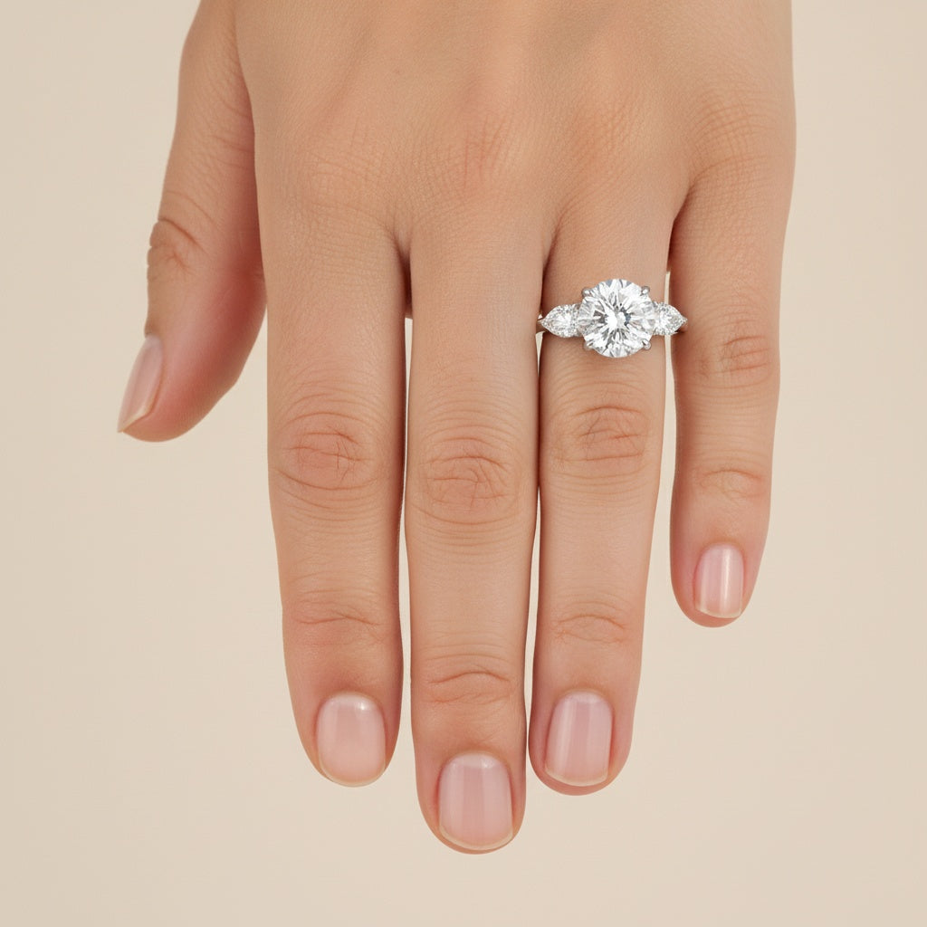 Aurevyn Moissanite 4.0 Ct Round Cut White Gold Engagement Ring with Pear Cut Side Stone